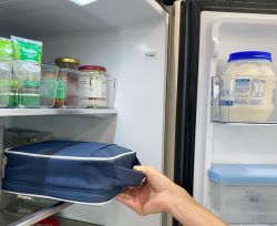 Insulated lunch bag being pulled out of fridge 