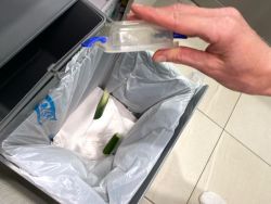 disposing left over food from lunchbox into bin