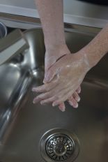image of someone with soap on their hands in a sink ready to be rinsed with sater 