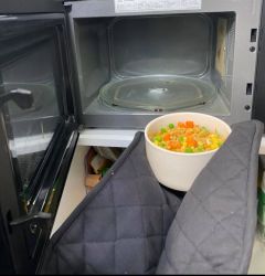 food being placed in the microwave for heating